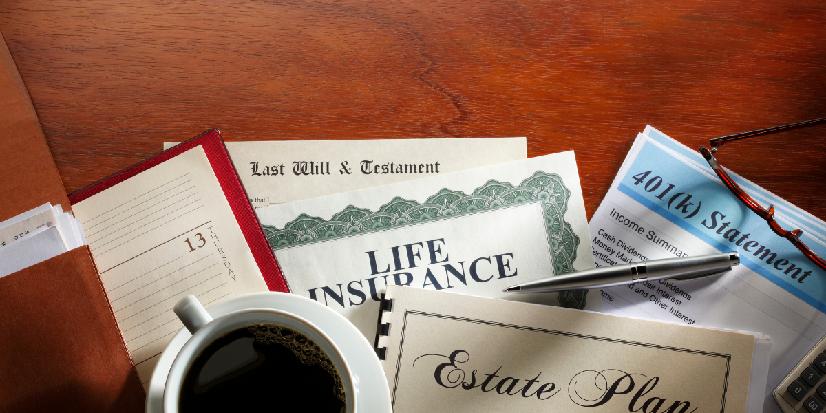 Documents and tools related to legacy planning, including a will, life insurance, and 401(k) statement on a wooden desk with coffee and a calendar.